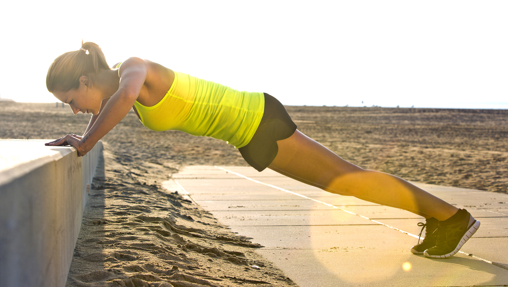 woman exercising while traveling, push ups